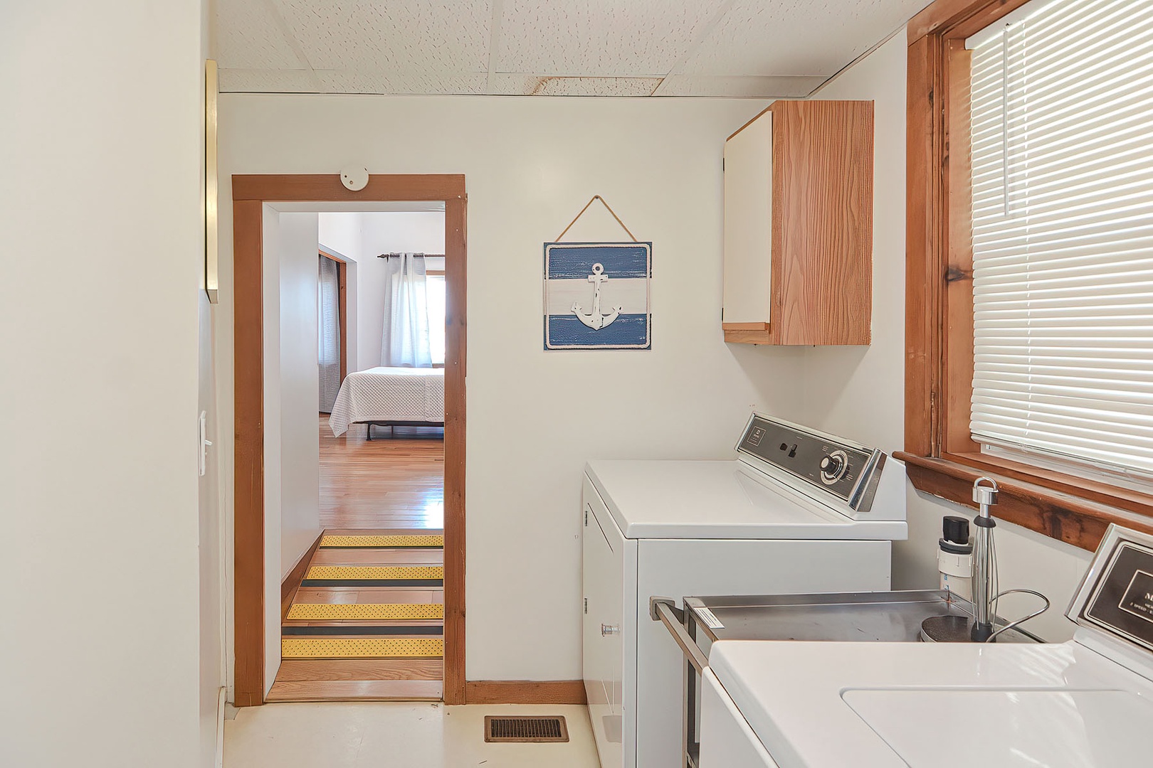 The laundry area is beyond the ground floor bedroom.