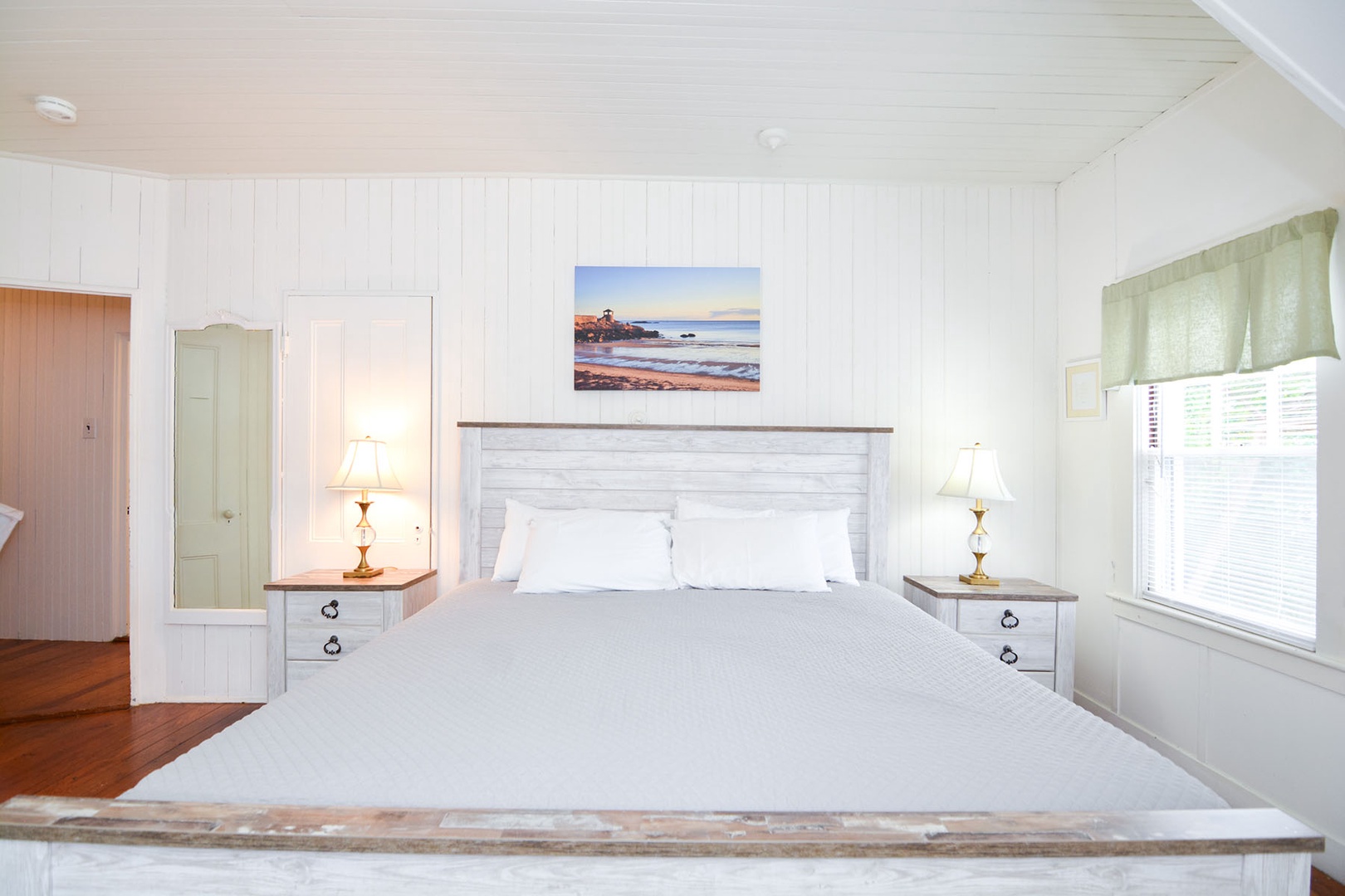 The Primary bedroom is a corner room with a King bed.