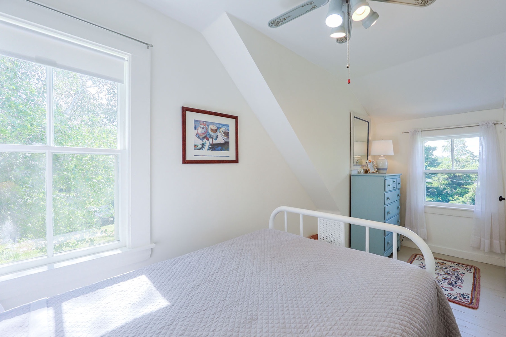 Bedroom 2 with a double bed & a ceiling fan.