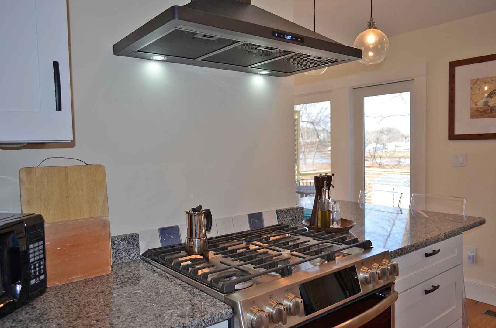 The kitchen has a 6-burner gas stove/oven.