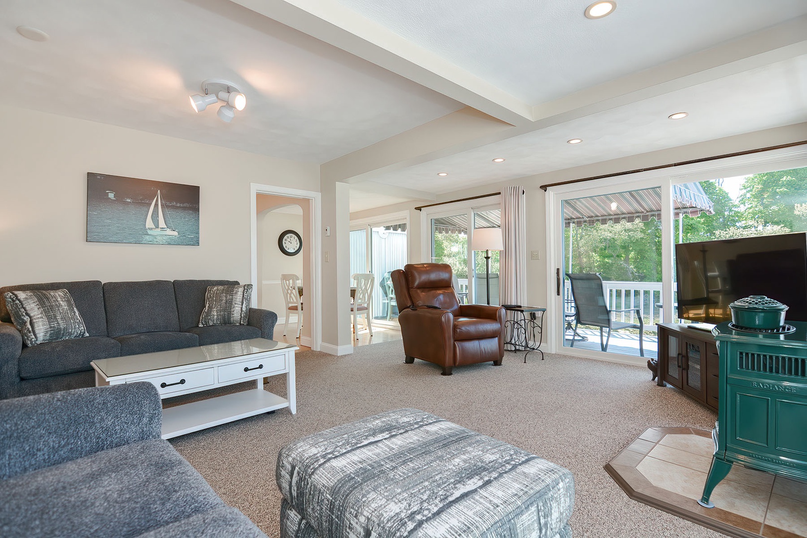 Living room contains a power recliner and a flat-screen smart TV.