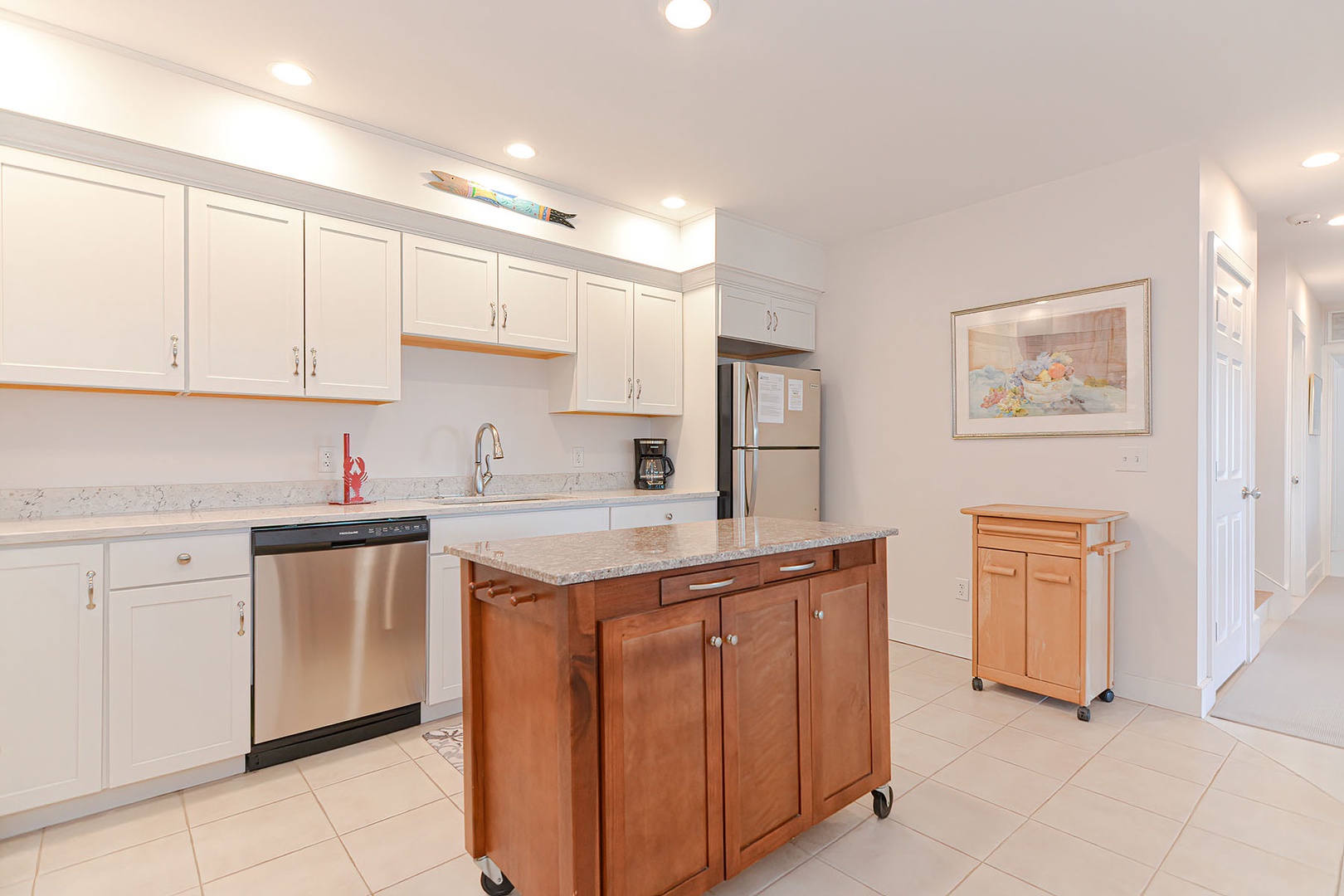 Bright kitchen with stainless appliances and granite counters.