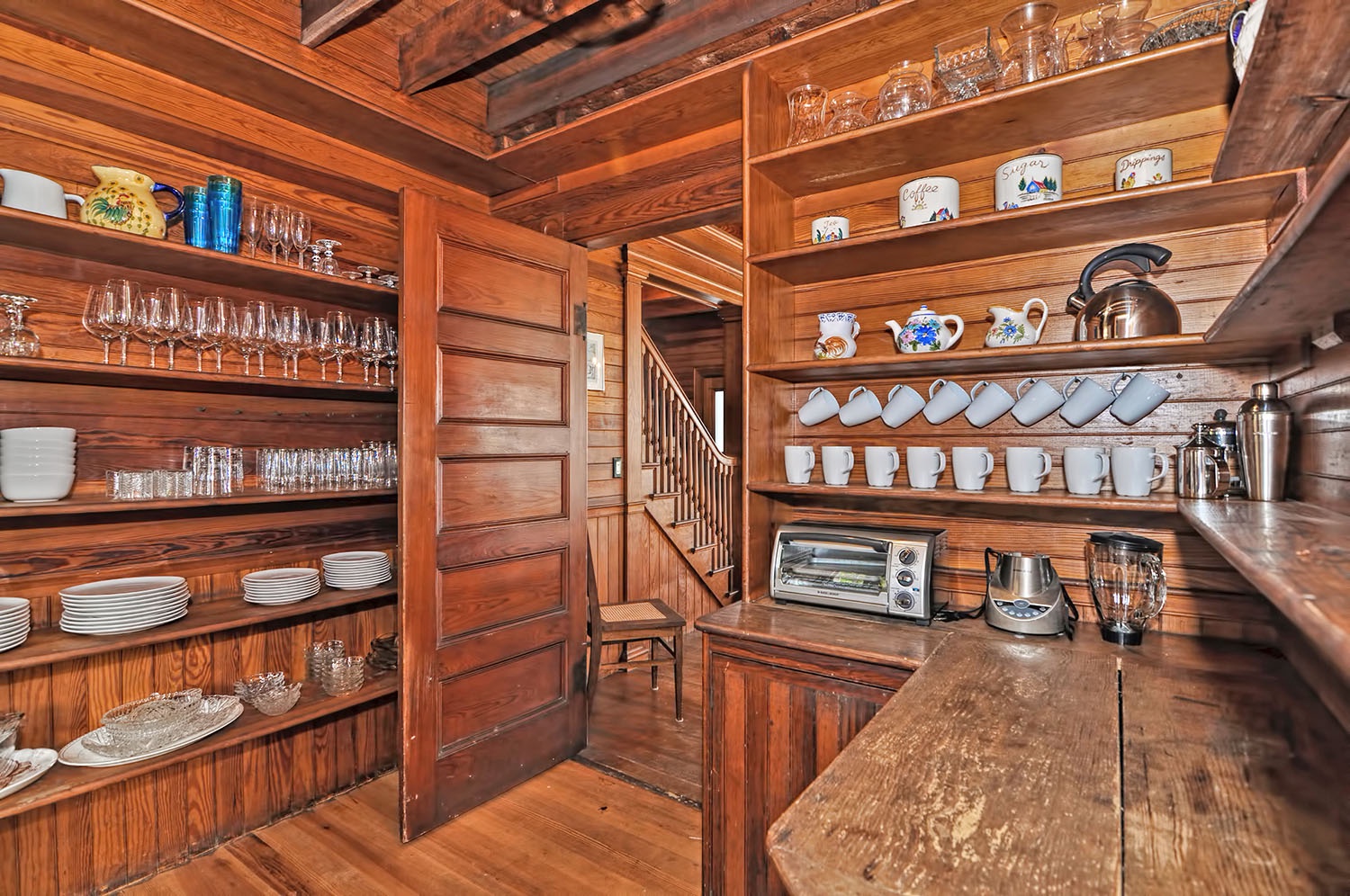 The pantry is well stocked with dishes, glassware, and more!