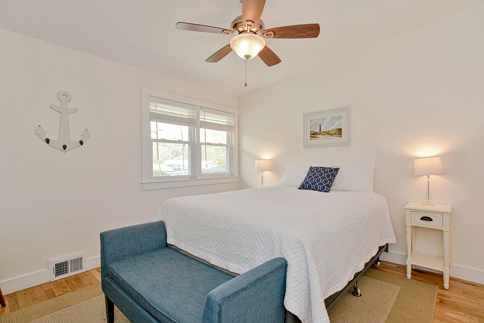 Bedroom 2 includes a ceiling fan and views out to the street.