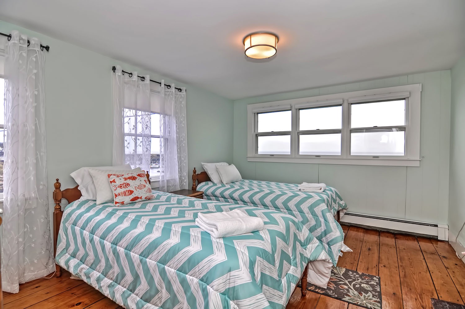 Bedroom 3: Twin beds and a view of Pigeon Cove.