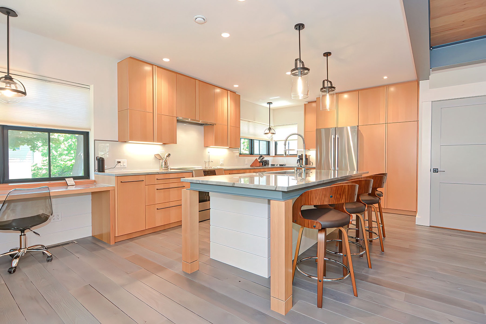 Beautiful honey-colored wood cabinetry and granite countertops in the kitchen.