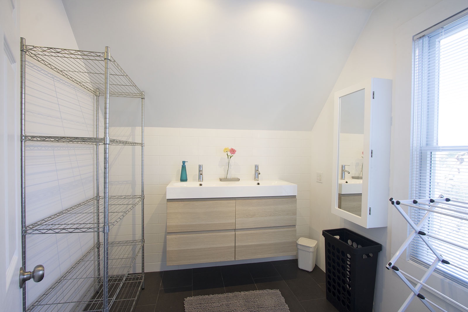 Upstairs is a European-style full bath with walk-in shower.