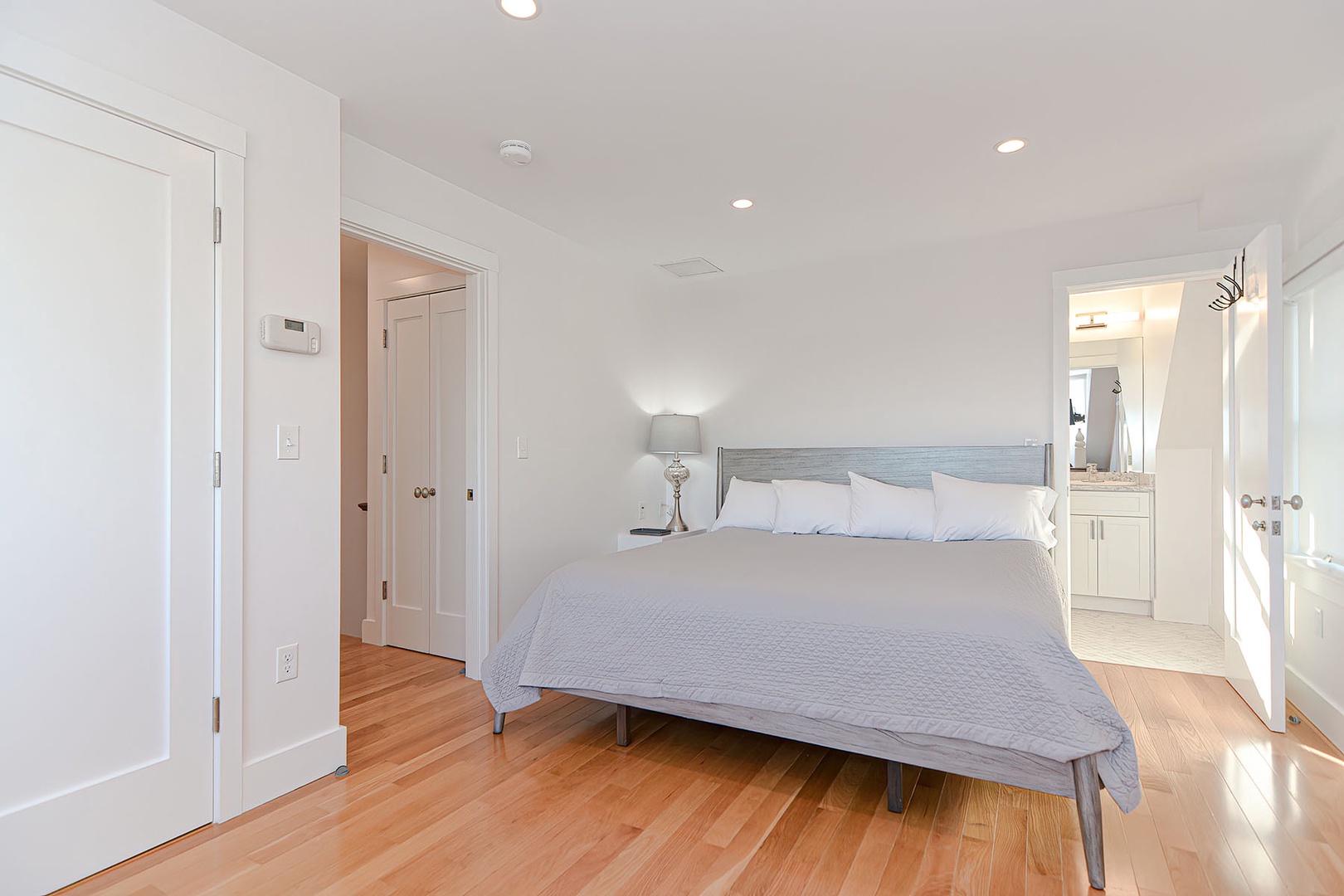 Primary bedroom with water view and TV