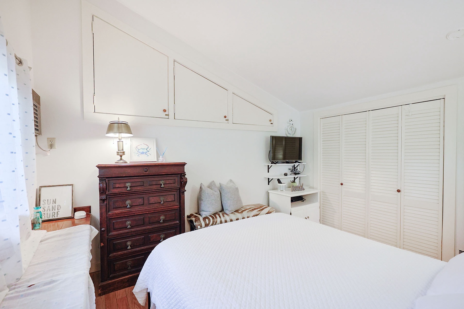 The queen bedroom includes a flat-screen TV.