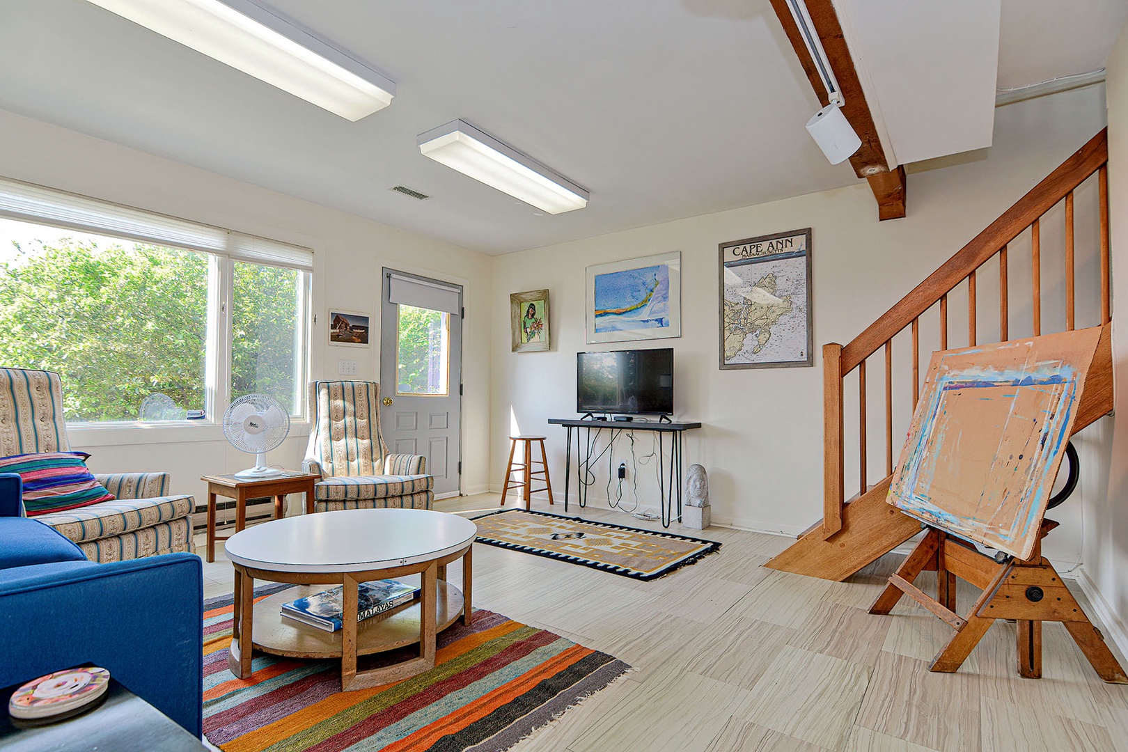 Ground level sitting room with flat screen tv.