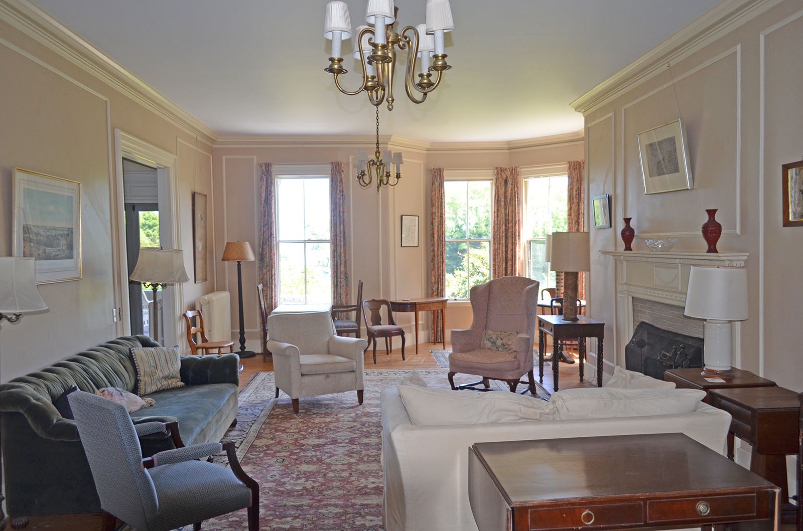 Formal living room with fireplace and floor-to-ceiling windows.