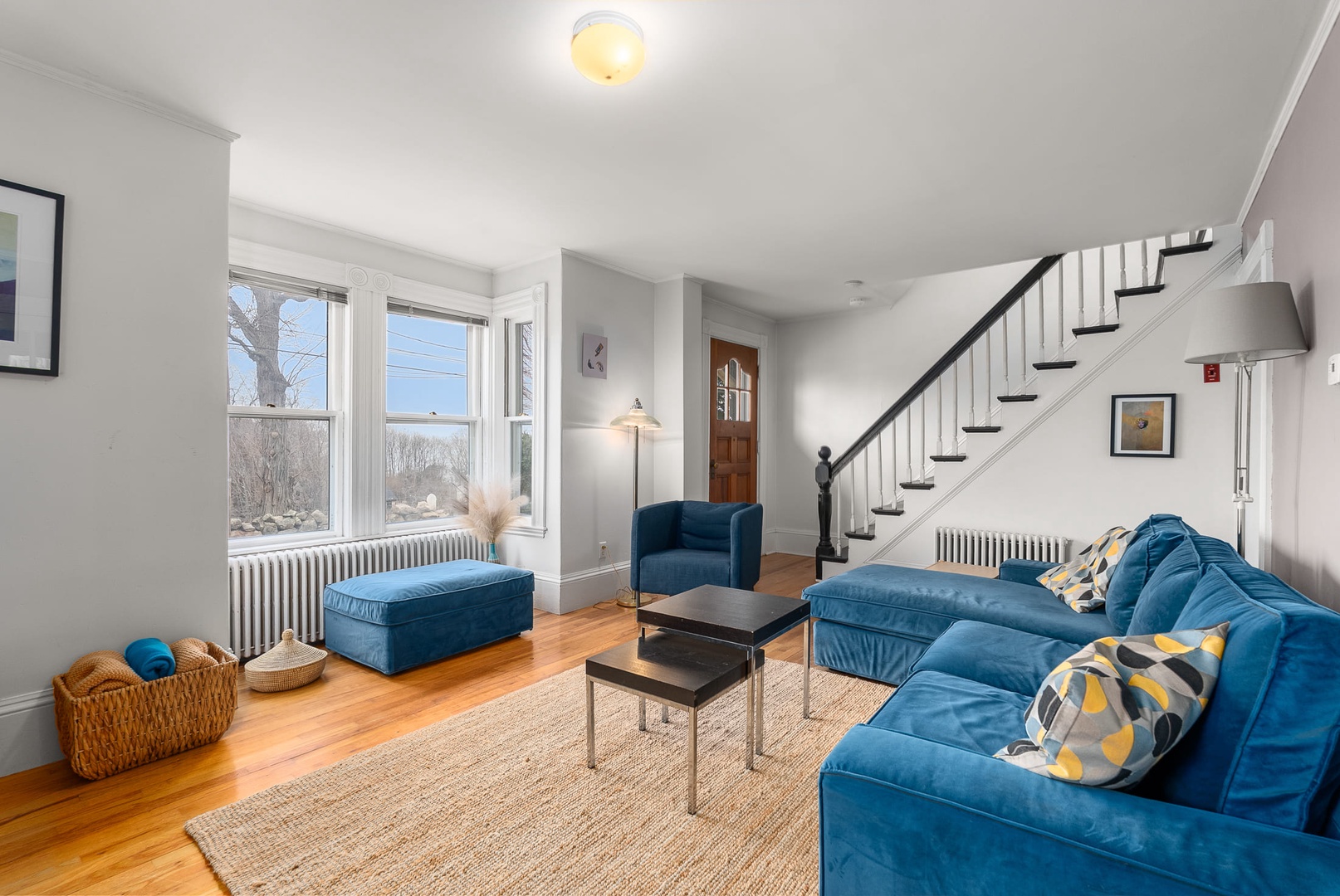 Spacious living room with natural lighting and comfortable seating.