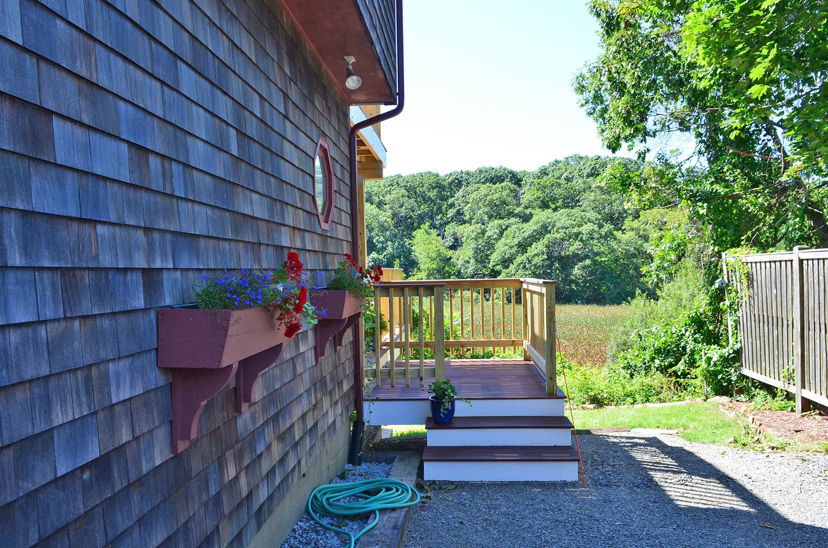 The driveway, with steps to the deck and main door to the home.