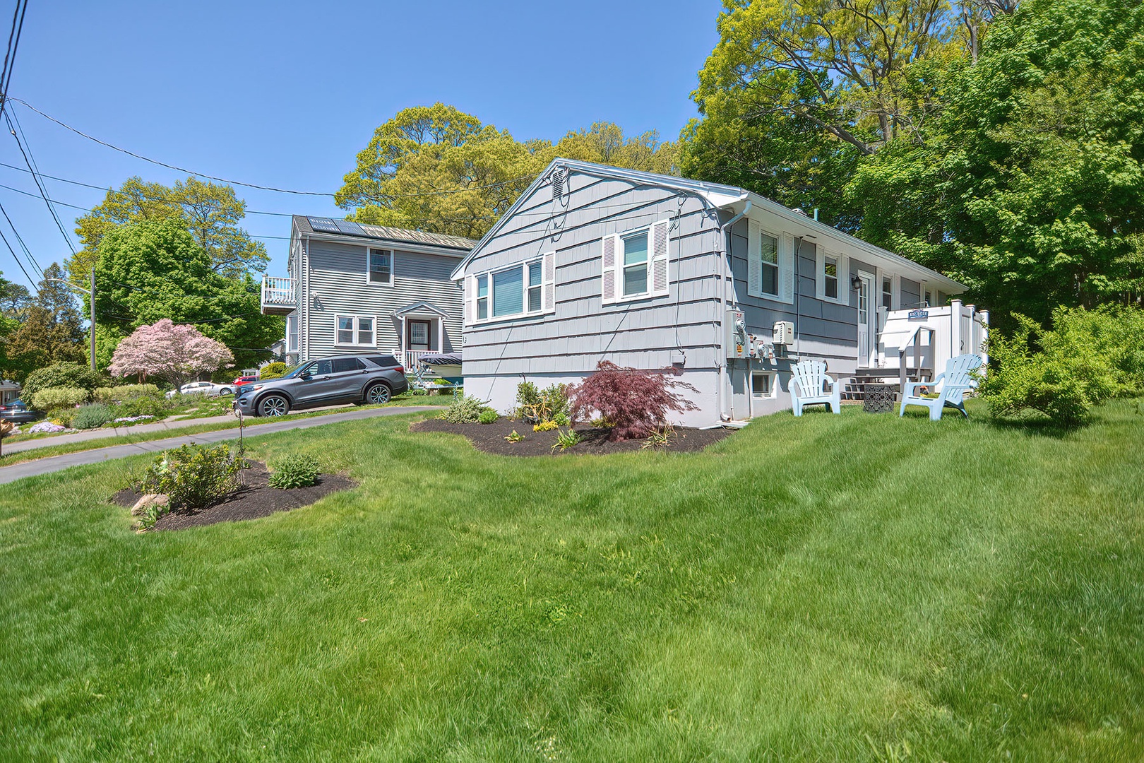 The outdoor shower is located on the right-hand side of the house.