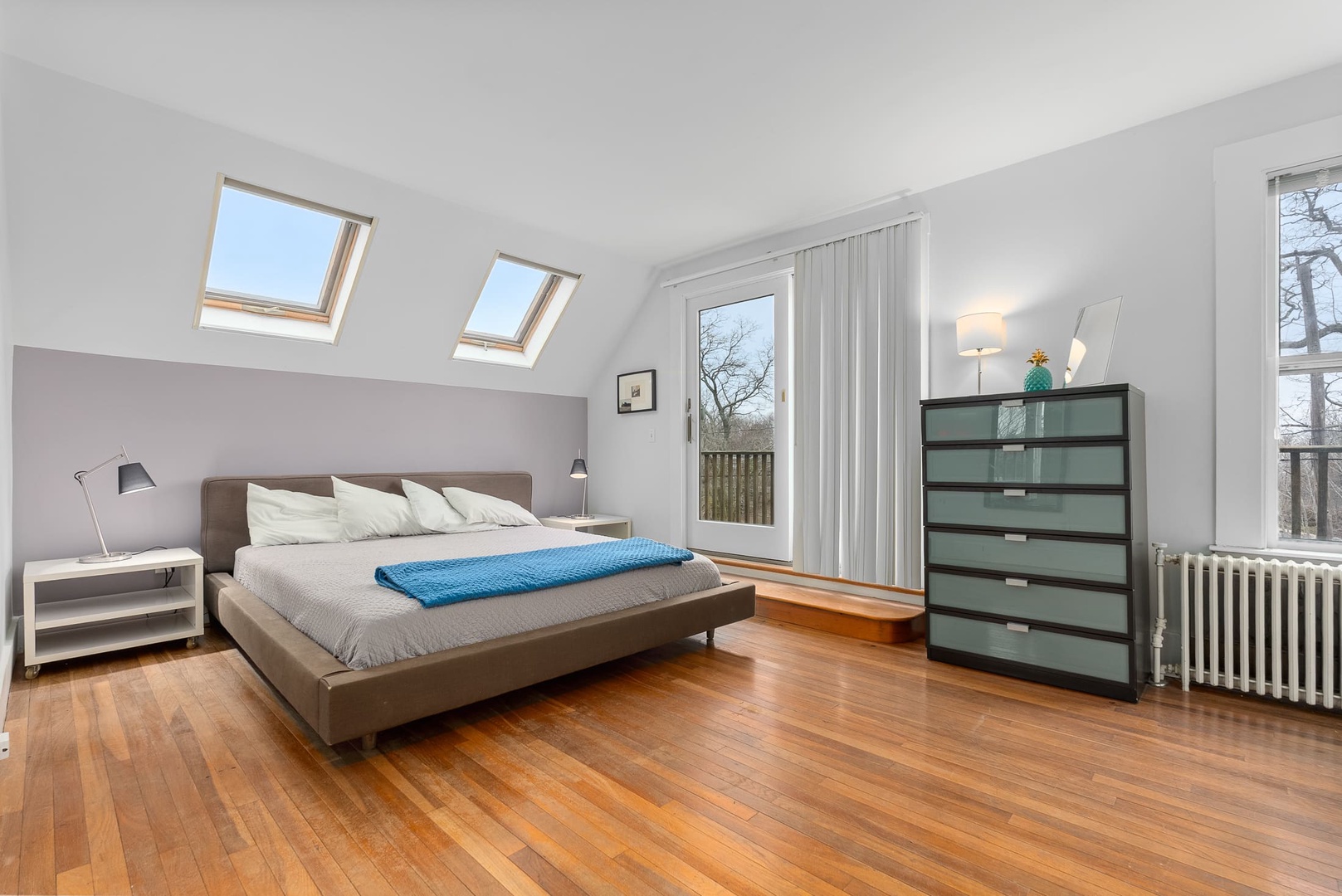 Primary bedroom with a King bed and slight water views from the deck.
