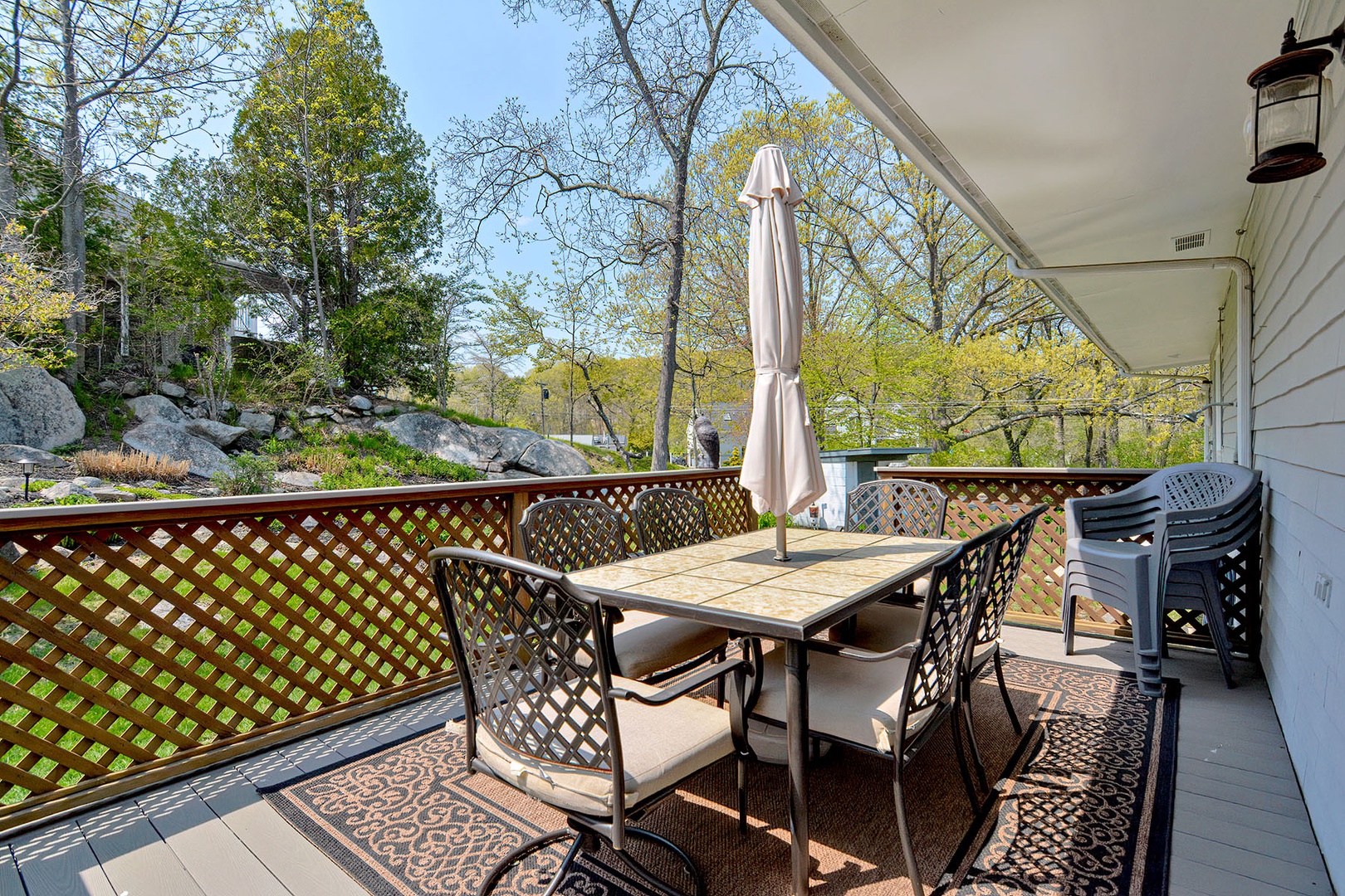 Table and chair with umbrella  outside the house..