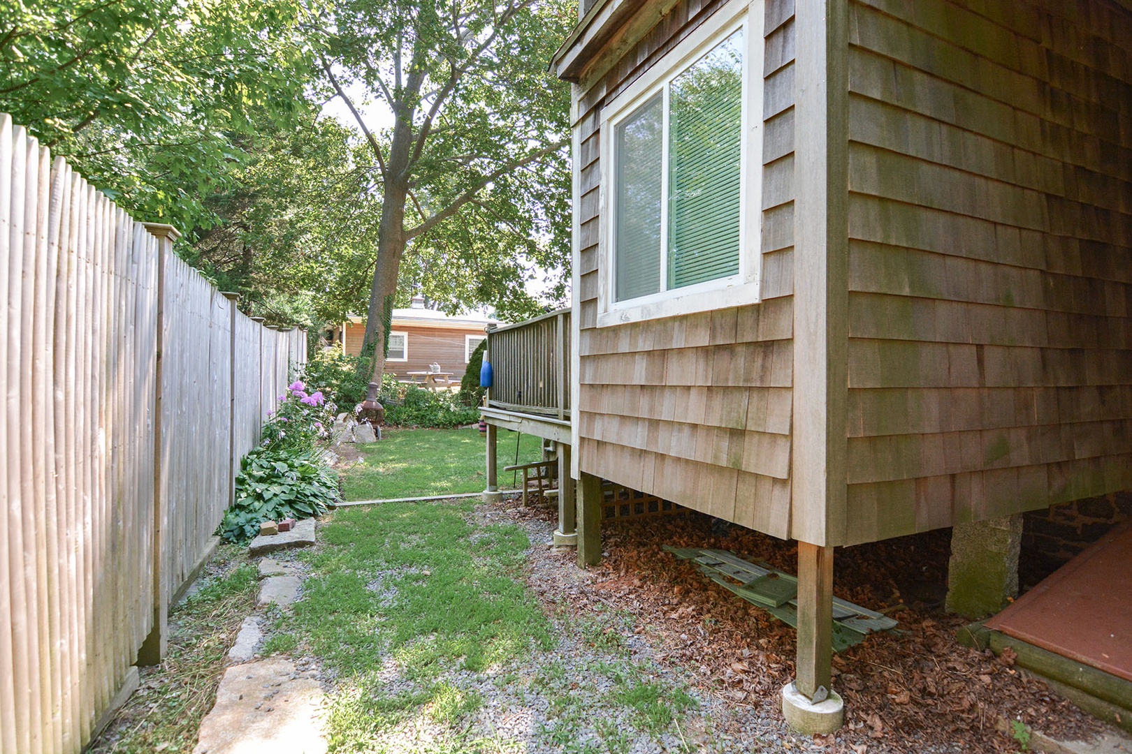 Backyard of the house and path to the driveway.
