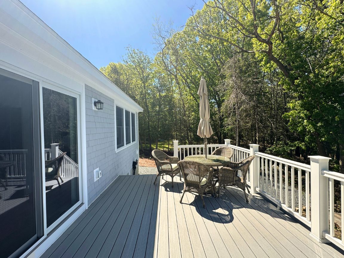 Back outdoor deck overlooking the forest and the pond.