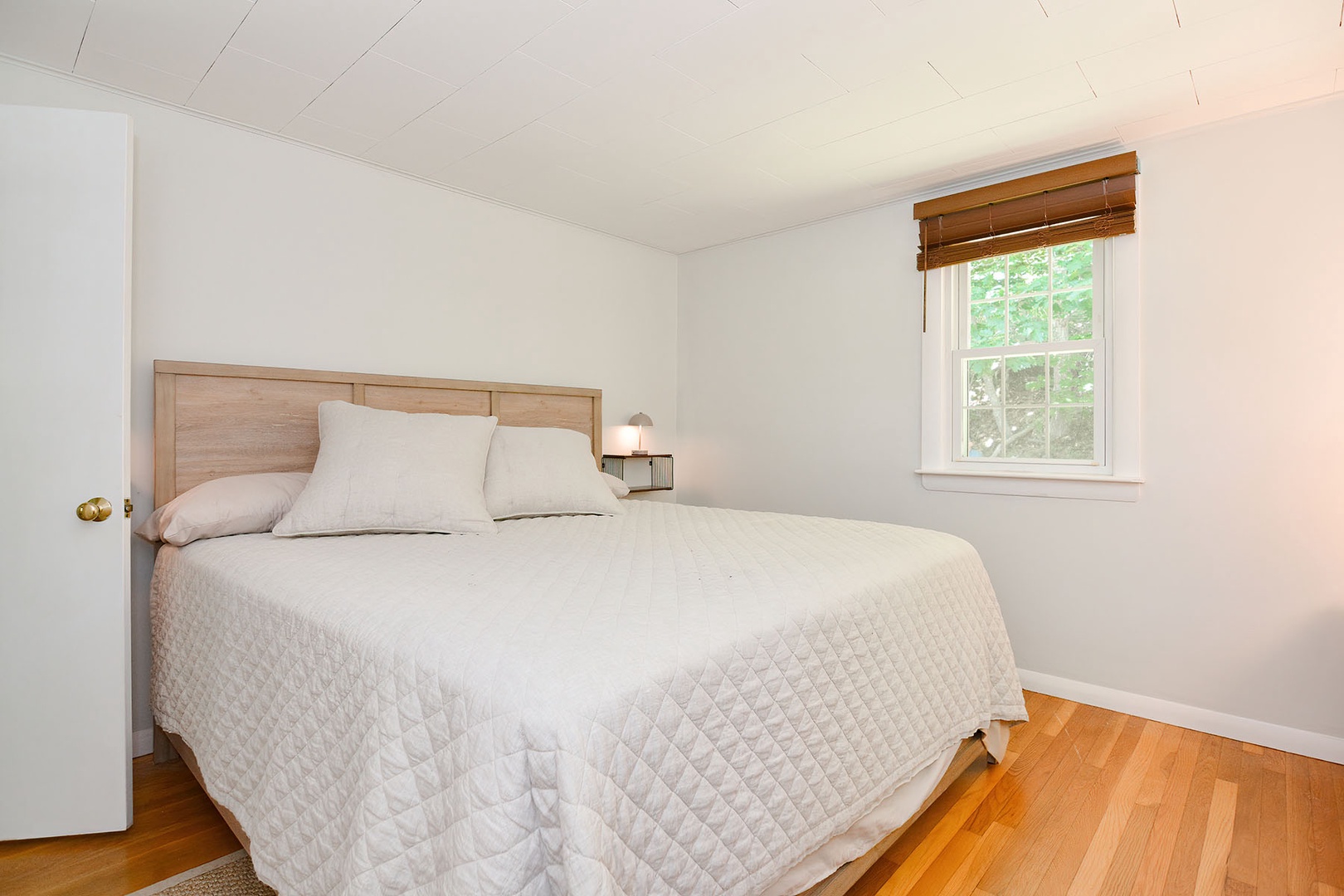 Primary king bedroom with plenty of natural light.