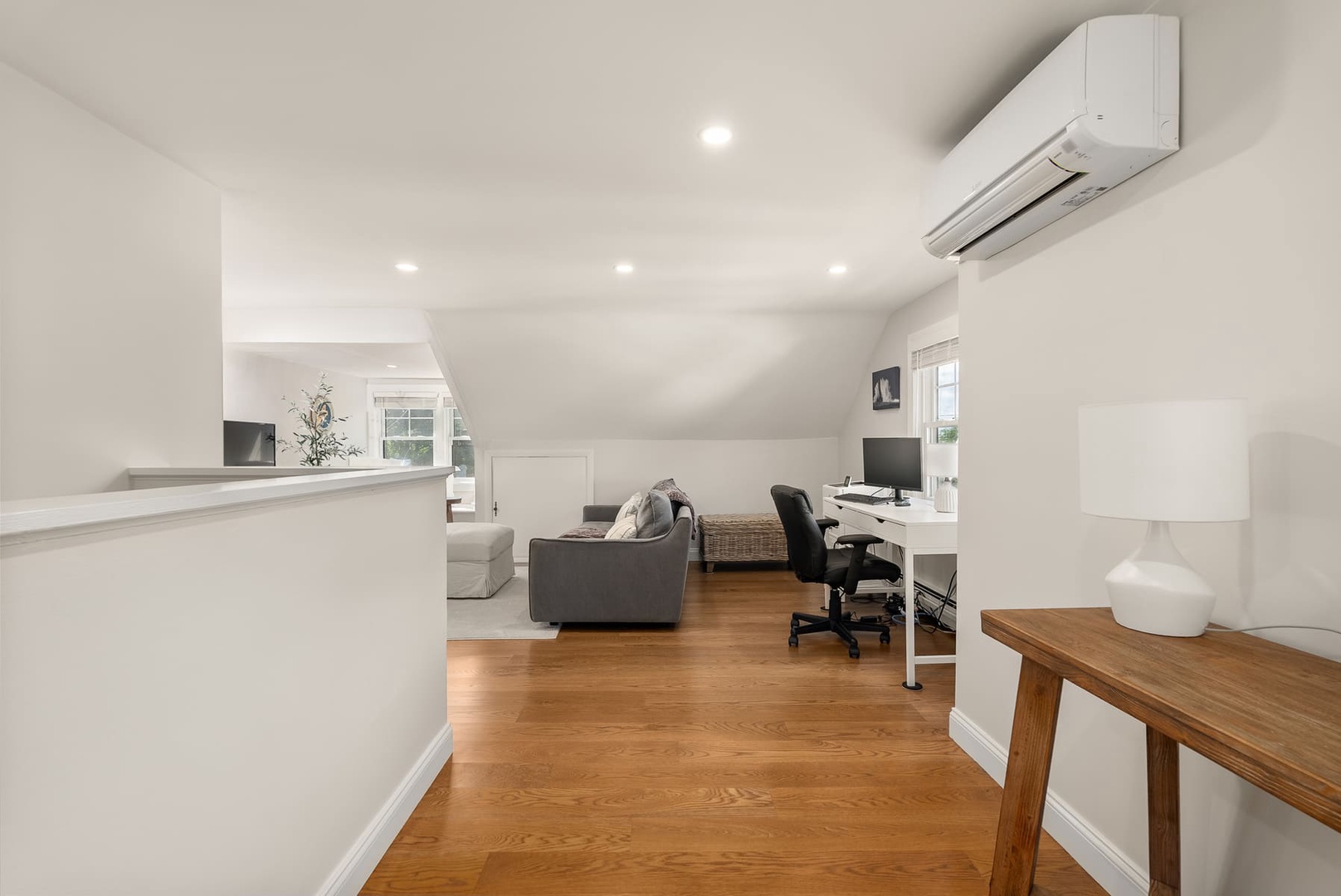 This living room also features a workspace with a desk.