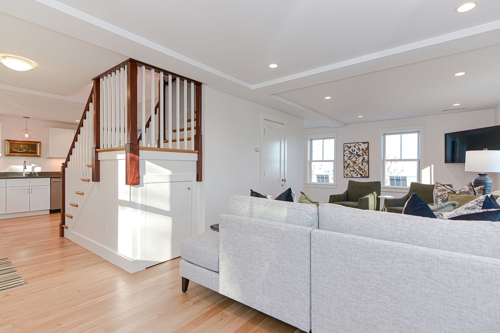 Walk pass the living room towards the staircase.