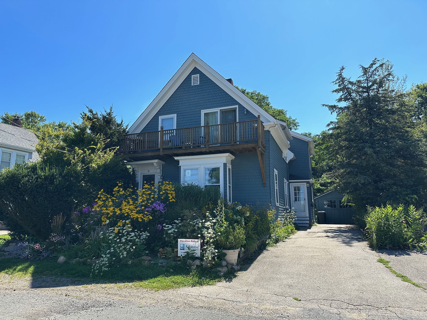 Front of the house and driveway to the right.