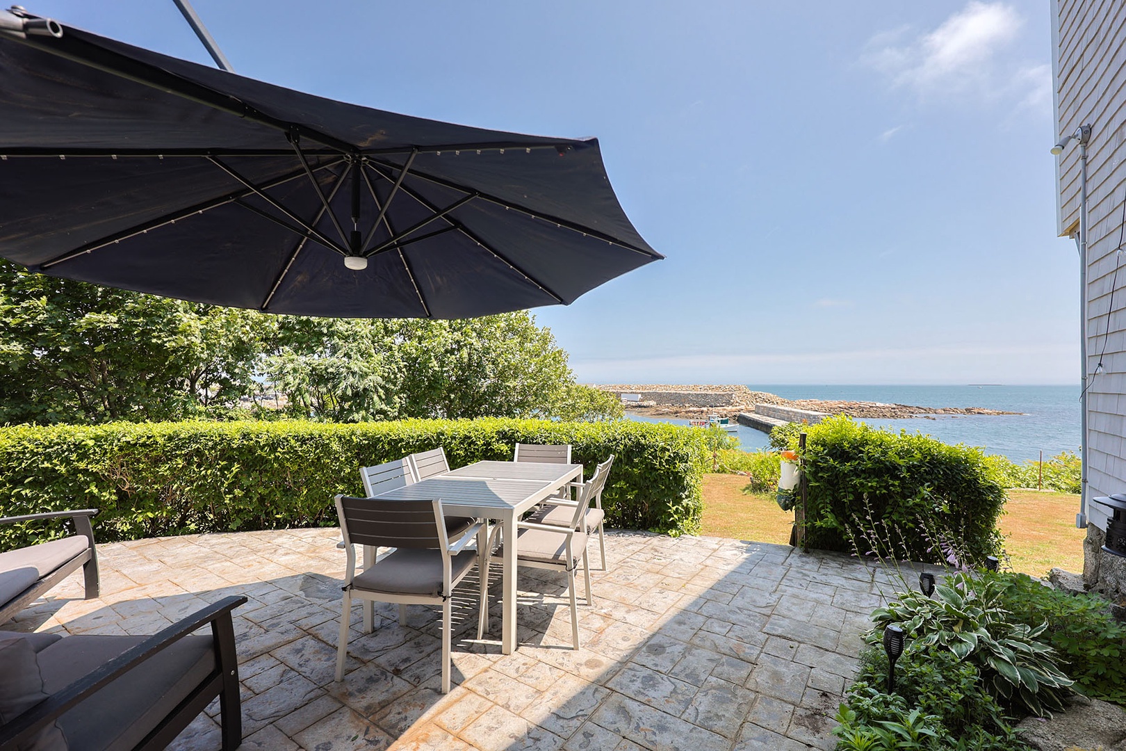 Patio with seating and beautiful waterfront views.
