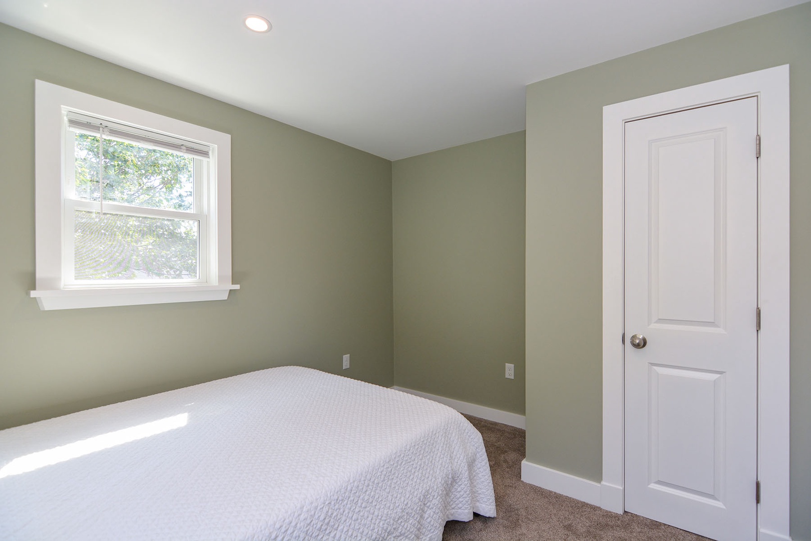 The primary bedroom with a Queen bed and AC.