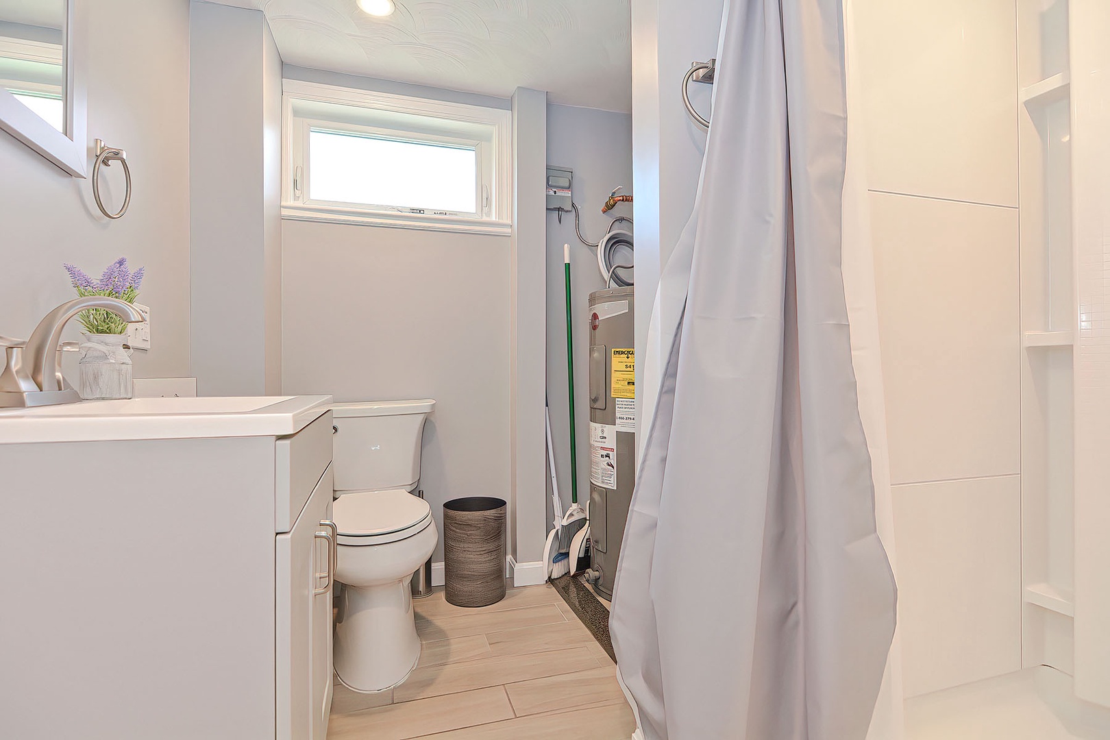The bathroom has a walk-in shower, and washer/dryer