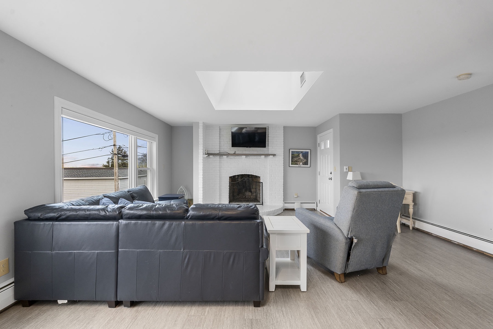 The living room is spacious and includes a TV.