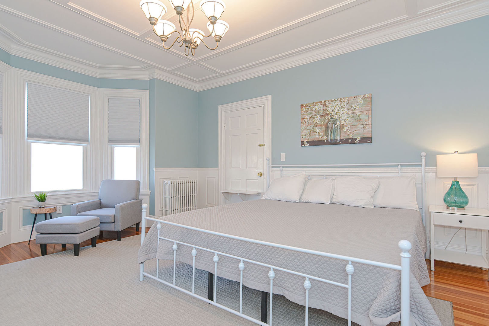 Primary bedroom with bay window and King bed.