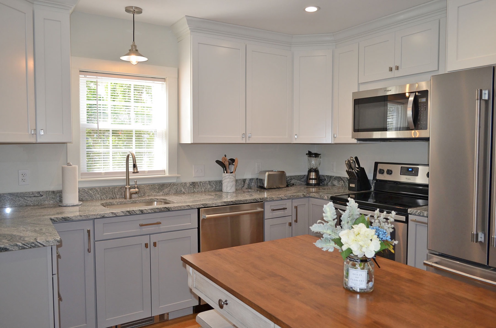 The kitchen features modern appliances and granite counter tops.