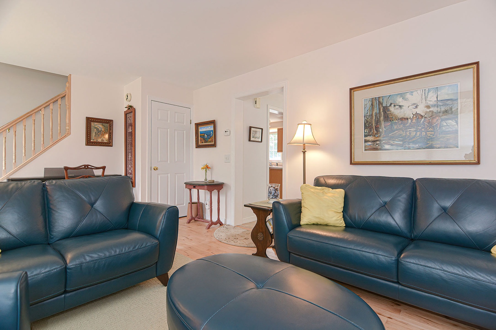 Living room with leather sofas and fireplace.