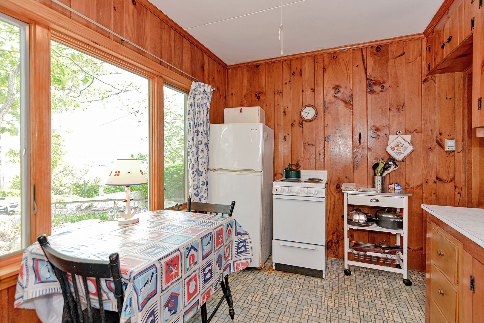 The kitchen is equipped with a refrigerator, stove, and microwave.
