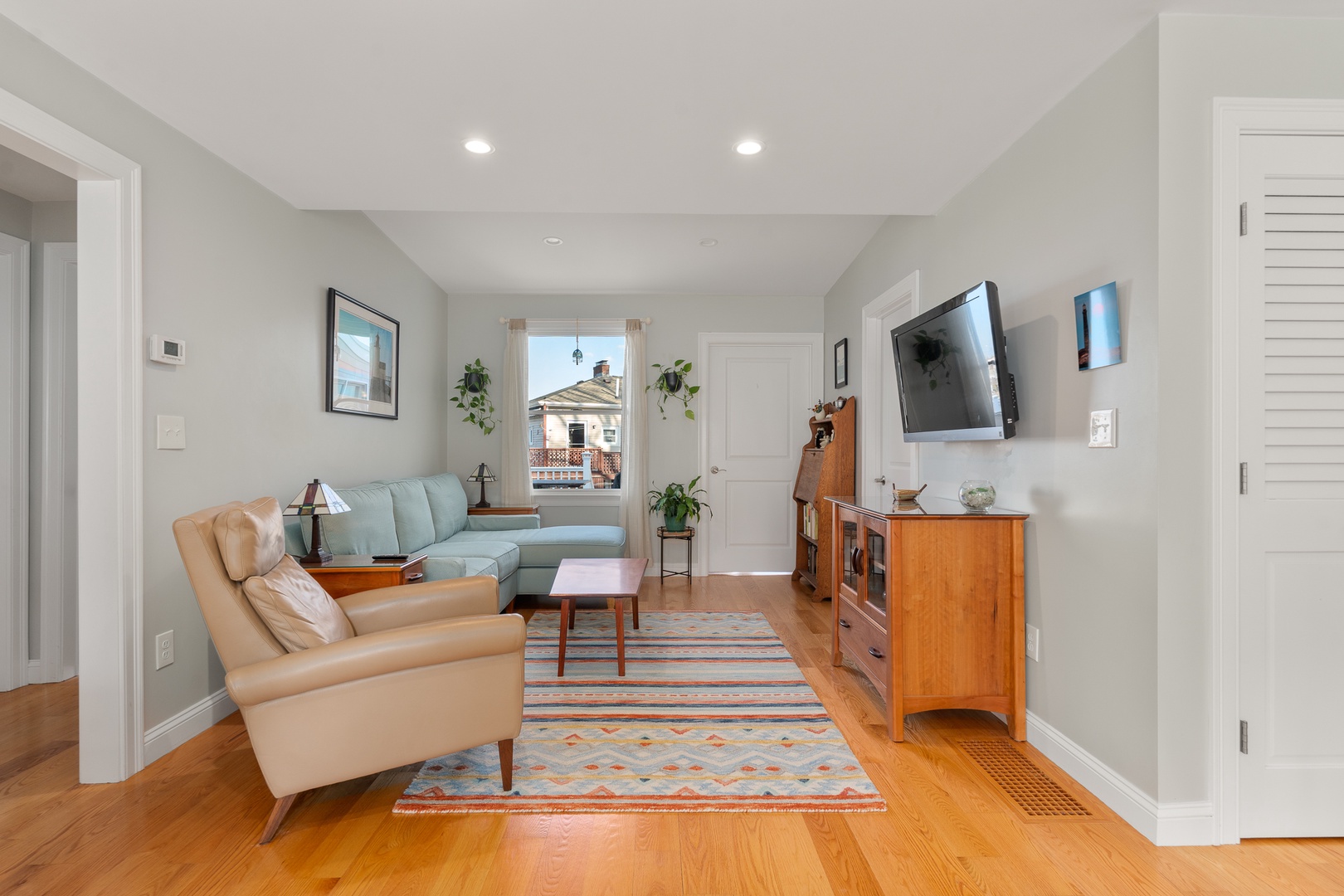 The living room is spacious and includes a flatscreen TV.