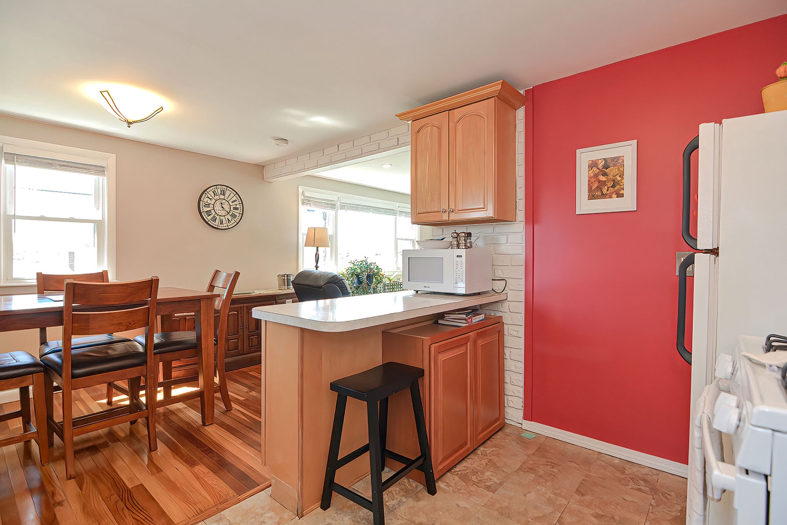 A breakfast bar separates the kitchen and dining rooms.