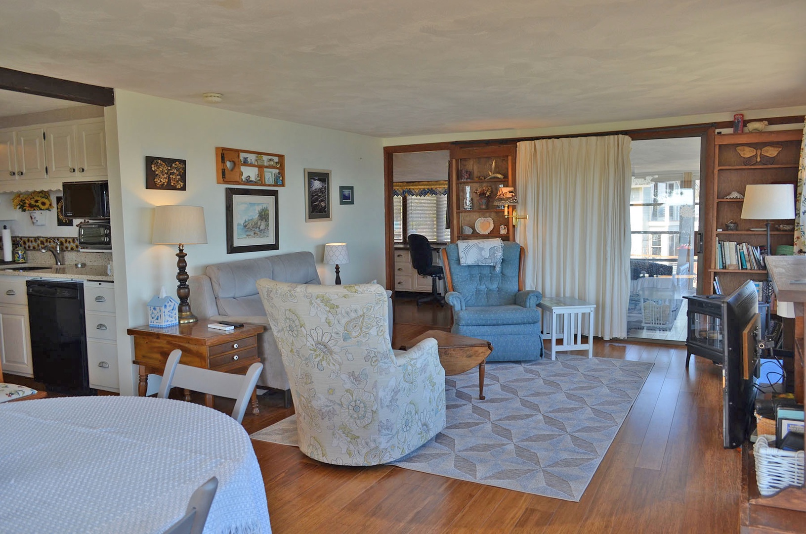 The living/dining area leads to the Kitchen and screened porch.