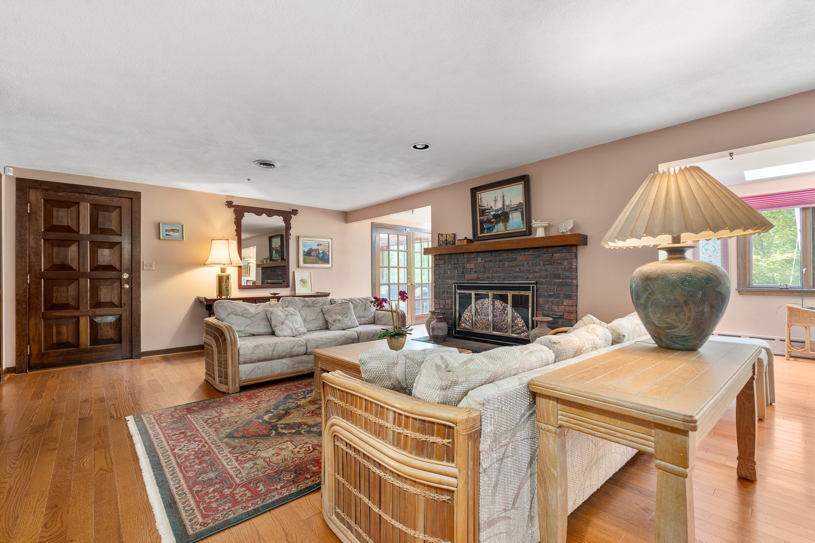The living room includes an ornamental fireplace.