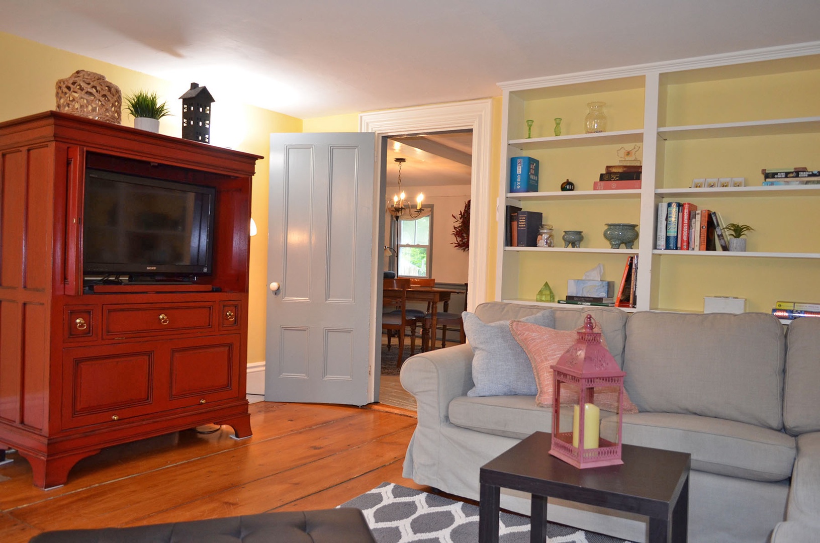 The TV is tucked into the beautiful hutch.