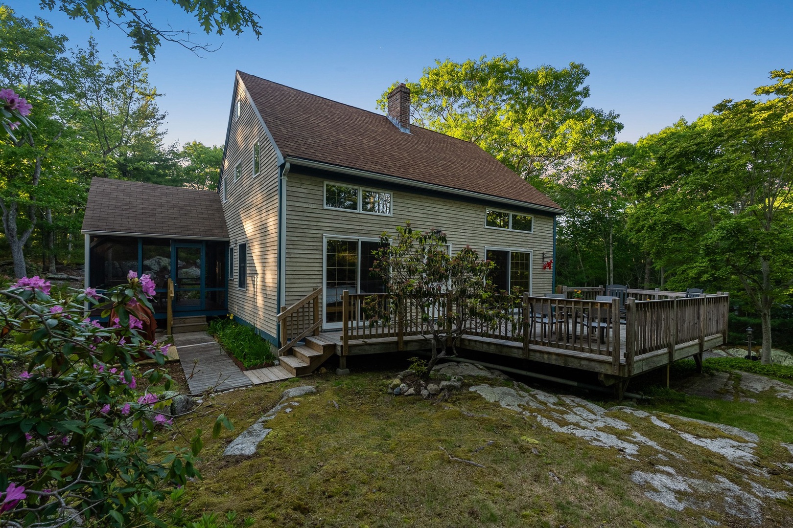 The house is nestled in a small forest.