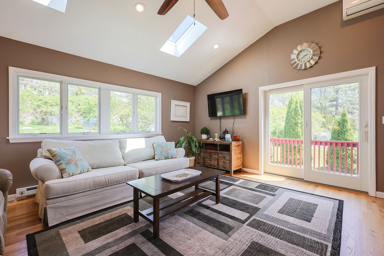 The den has a large flatscreen TV, plus access to the back yard