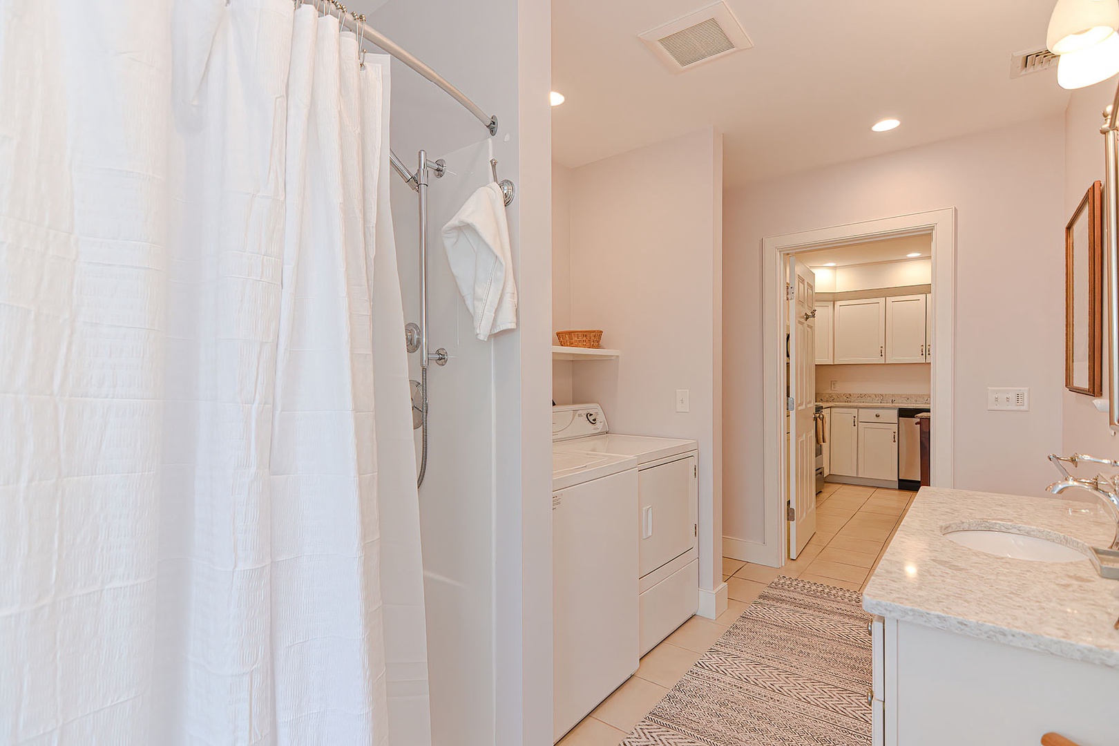 Full-bathroom located just off the kitchen, the washer and dryer are also located here.
