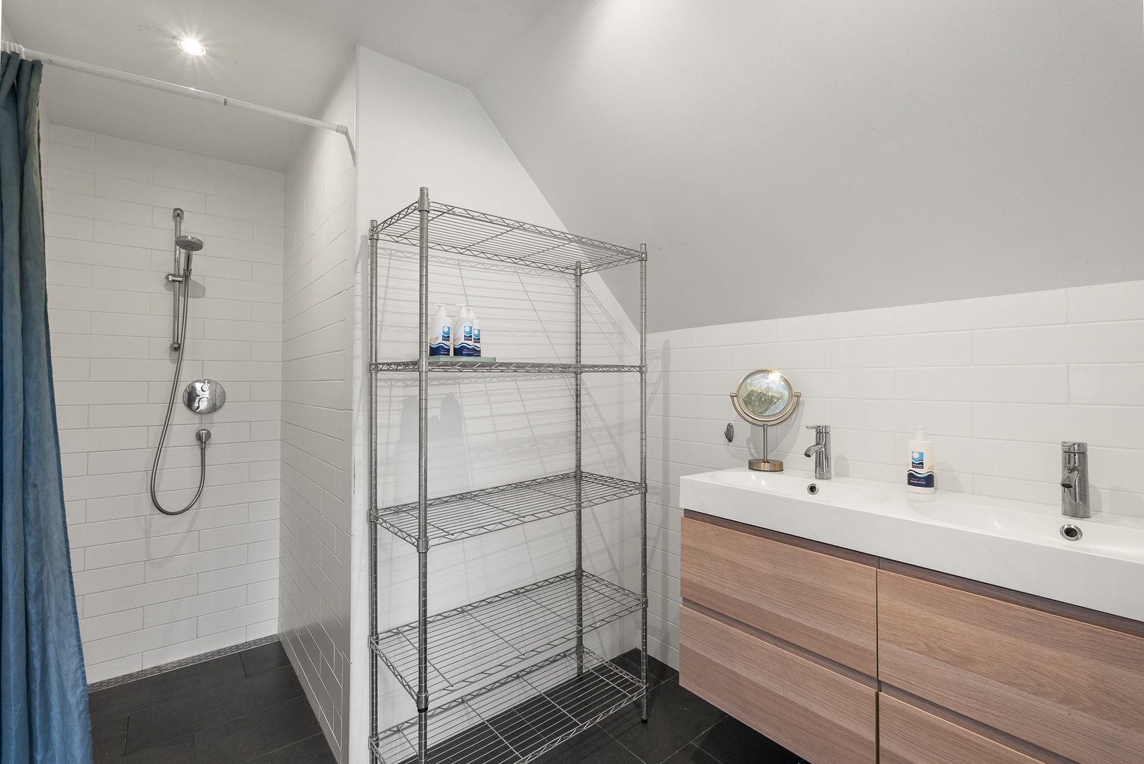 Upstairs is a European-style full bath with walk-in shower.
