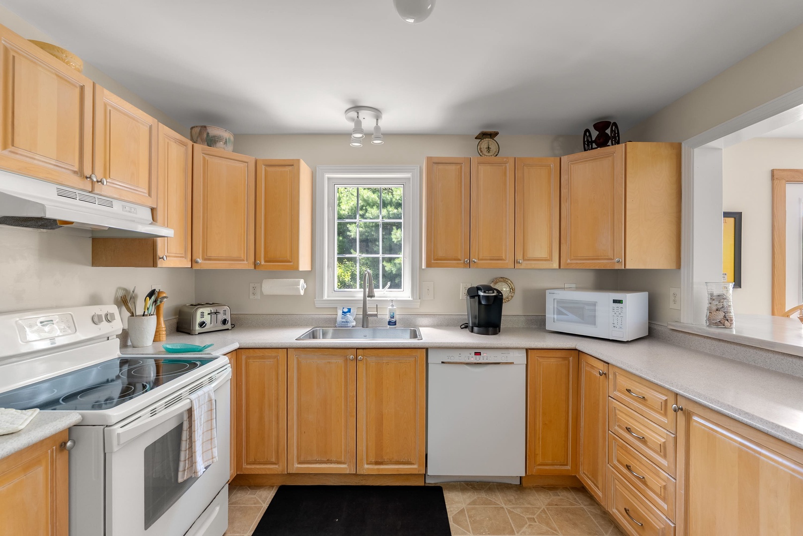 The kitchen has ample counter space and storage for meal prep.