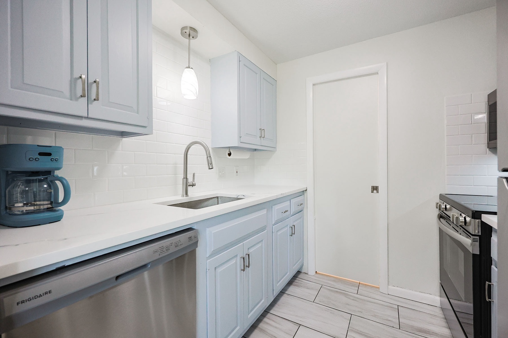 Kitchen offers generous cabinet and drawer storage.