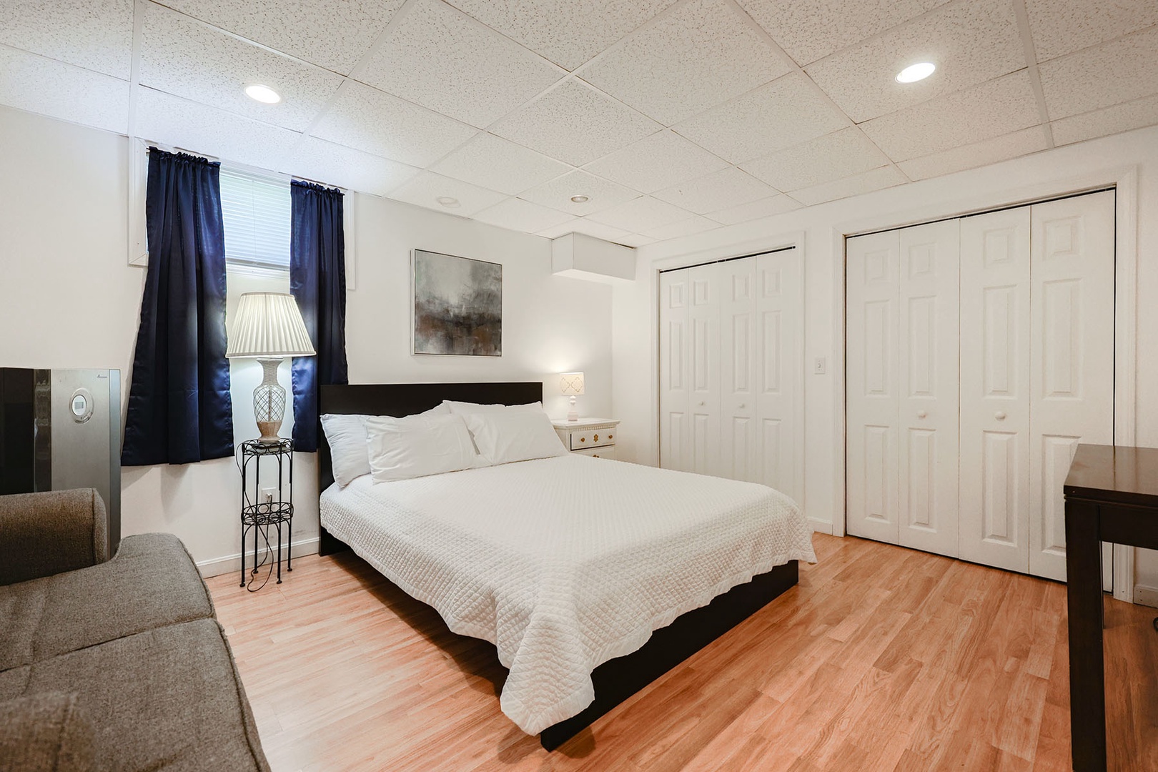 Garden level bedroom with a queen bed