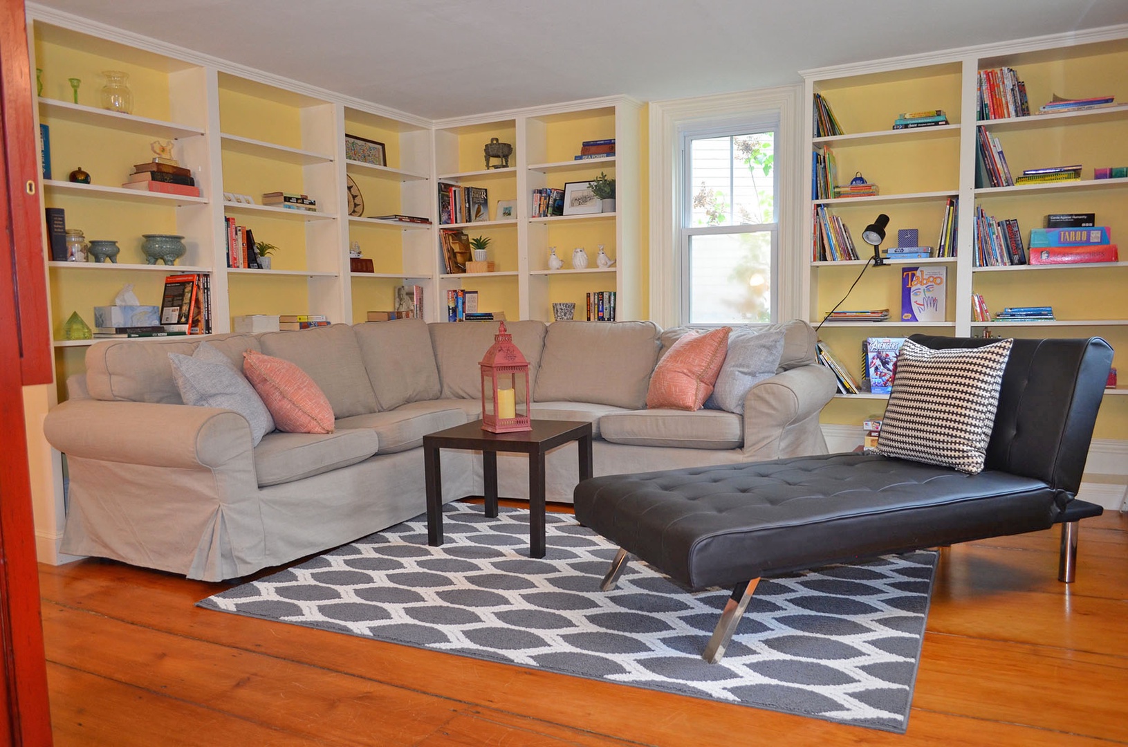 The den has comfortable seating and built-in bookshelves.