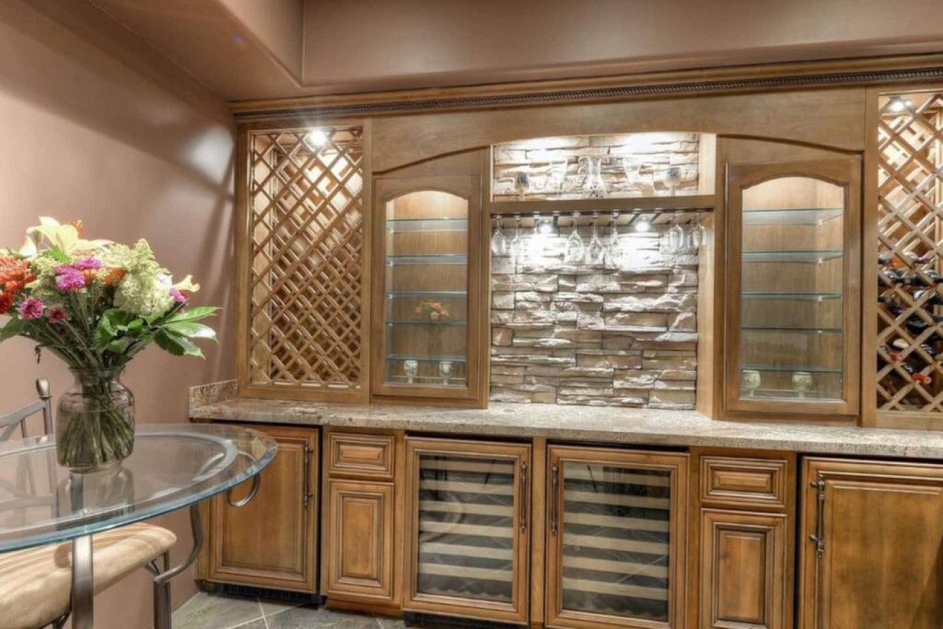 Your elegant wine storage features custom cabinetry with glass displays, perfect for entertaining memorable evenings.