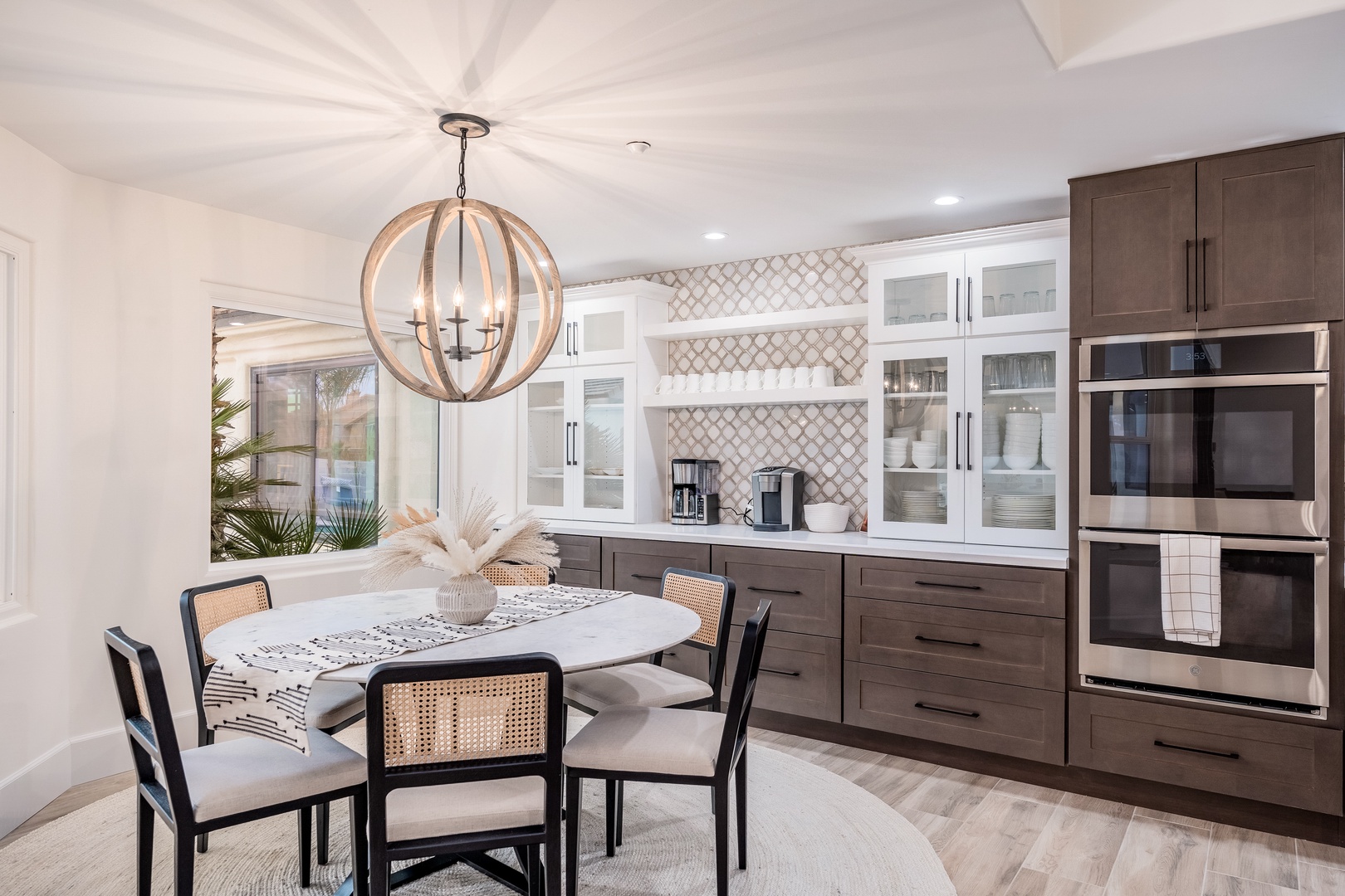 Step into your stylish dining kitchen where warm wood tones meet modern elegance. Picture yourself gathered around this inviting table, natural light streaming through windows as you savor meals together in comfort and style.