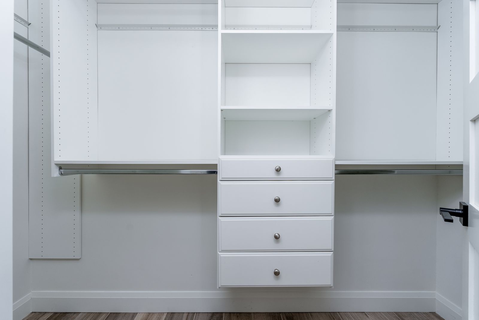 Your spacious walk-in closet features custom shelving, drawers, and dual hanging rods, giving you plenty of organized storage for all your belongings.